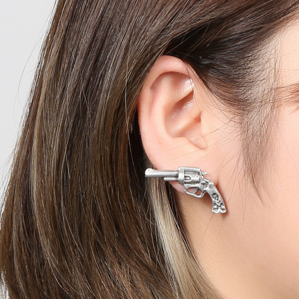 Niche storytelling rose and revolver shaped earrings